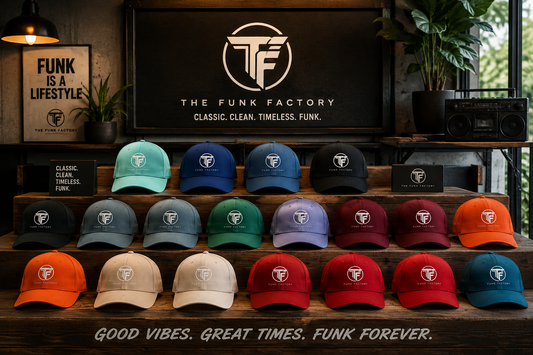 A retail display of The Funk Factory baseball caps arranged on wooden shelves, with a large black sign behind them reading 'THE FUNK FACTORY' and the brand's circular TF logo. Multiple color options are shown, including mint, navy, blue, green, purple, burgundy, orange, beige, red, and teal, each with a white embroidered TF logo.